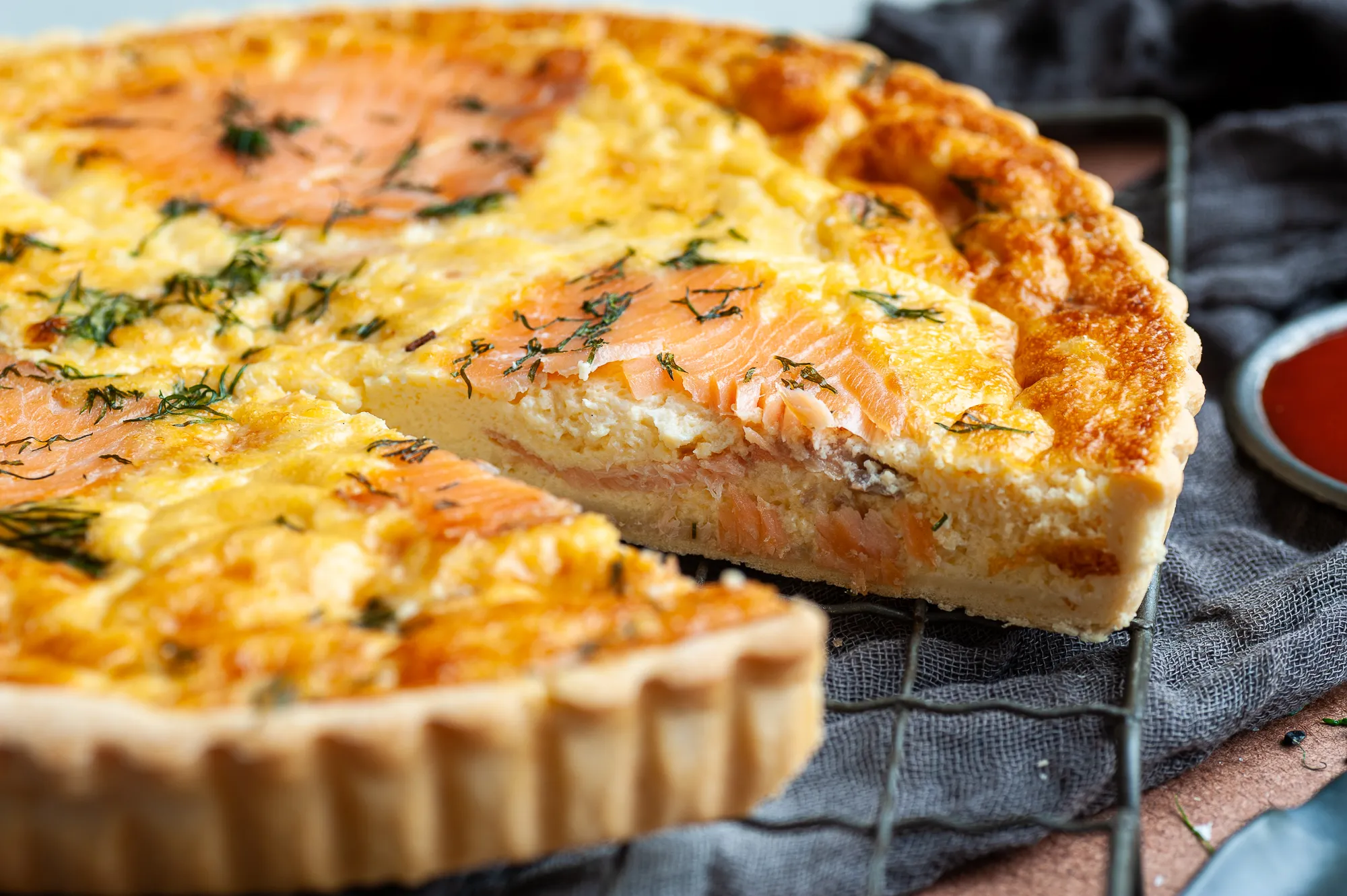 Salmon and dill quiche on a wire rack