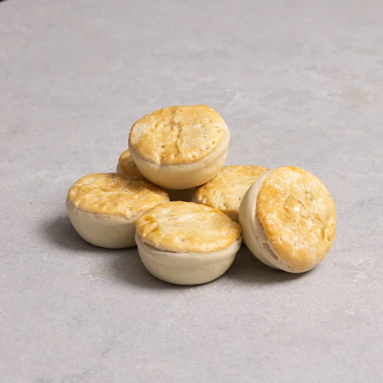 A pile of golden mini pies